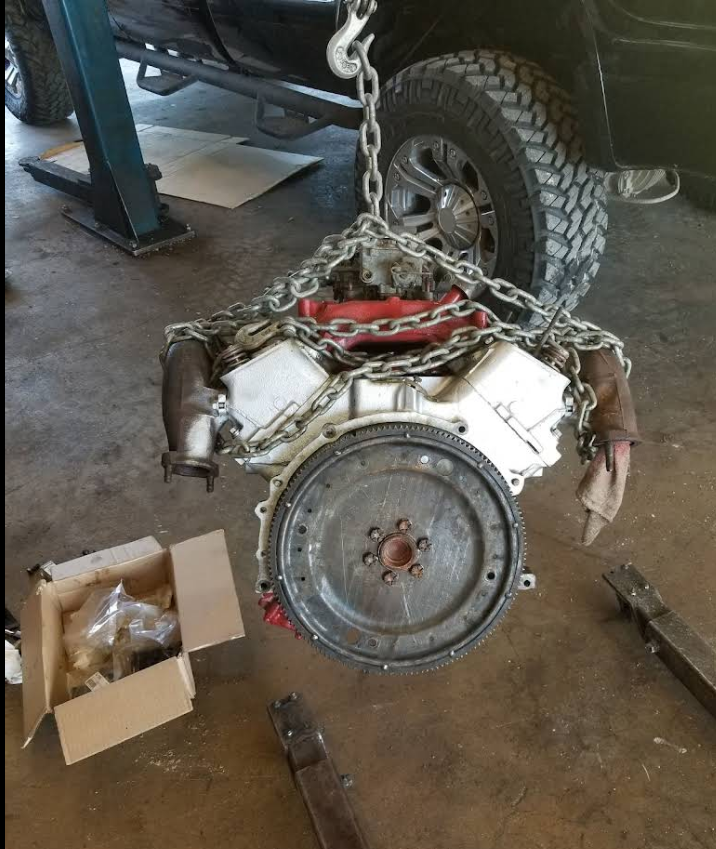 V8 engine removal and inspection on chain hoist